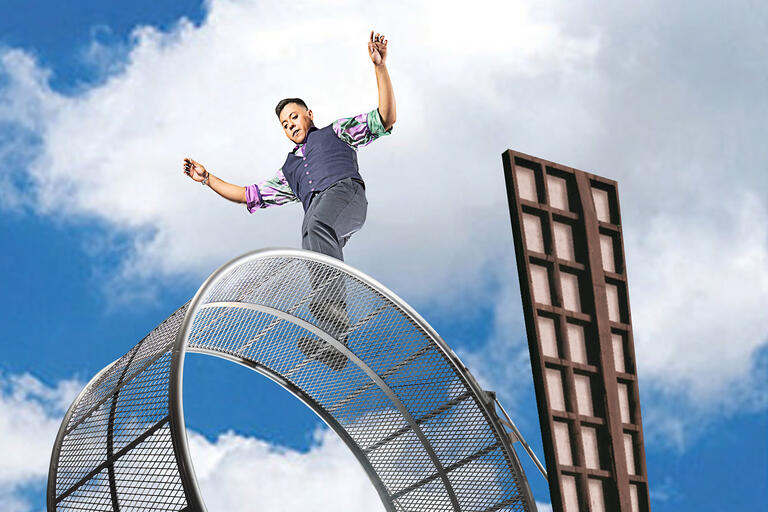 man walking on large ring in sky