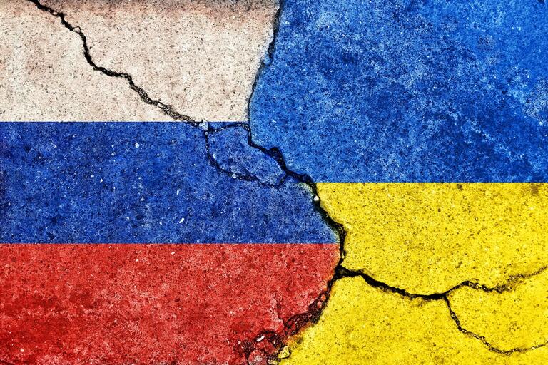 An illustration of Ukraine and Russia flag colors on cracked concrete