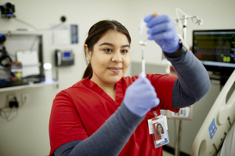 female nursing student holds syringe