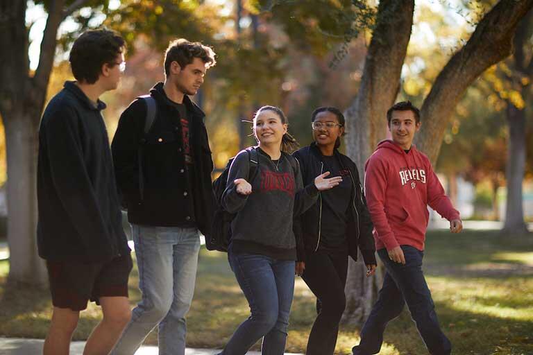 Diverse group of students walking on campus