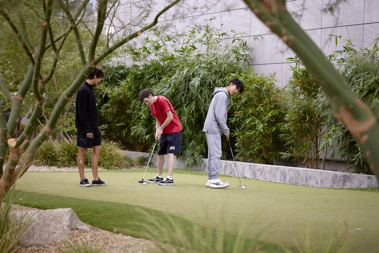 Students practice their putting.