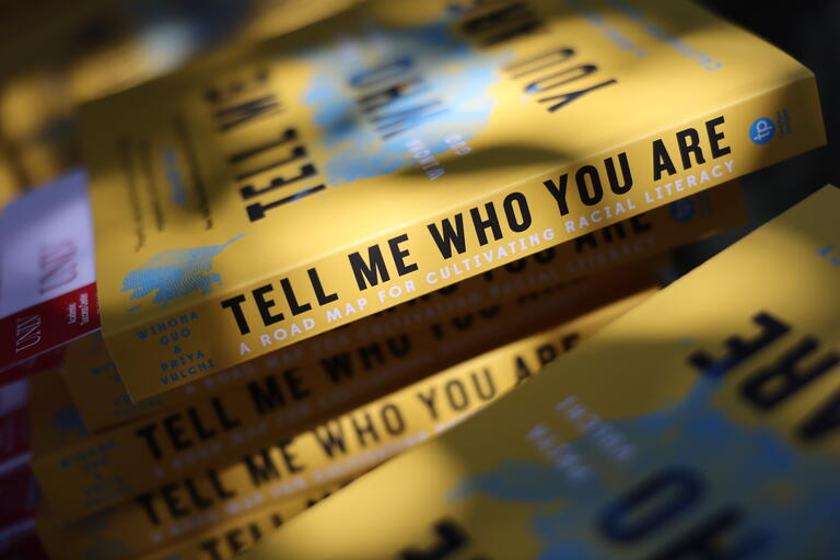 close up of book with the title reading &quot;tell me who you are&quot;