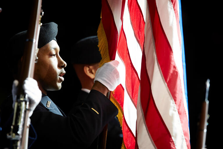 A UNLV ROTC student holds up an American flag.