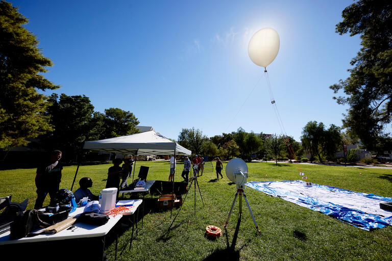 science balloon floating in front of sun
