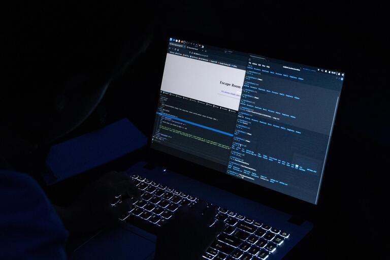 image of computer laptop screen in dark room