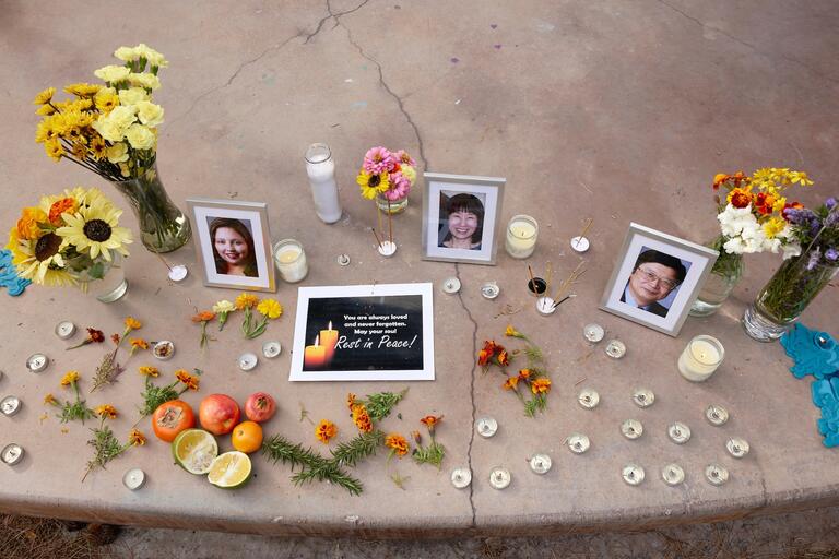 Candles, flowers, and messages surround the portraits of the three victims of the Dec. 6 shooting.