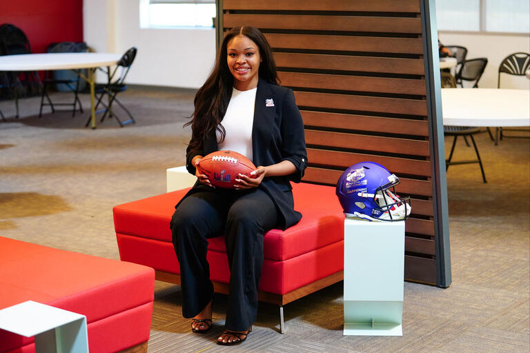 Portrait of third year law student D'ahna Scott holding a football