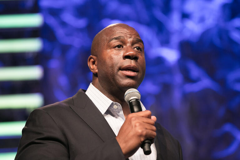 Magic Johnson speaking into a microphone