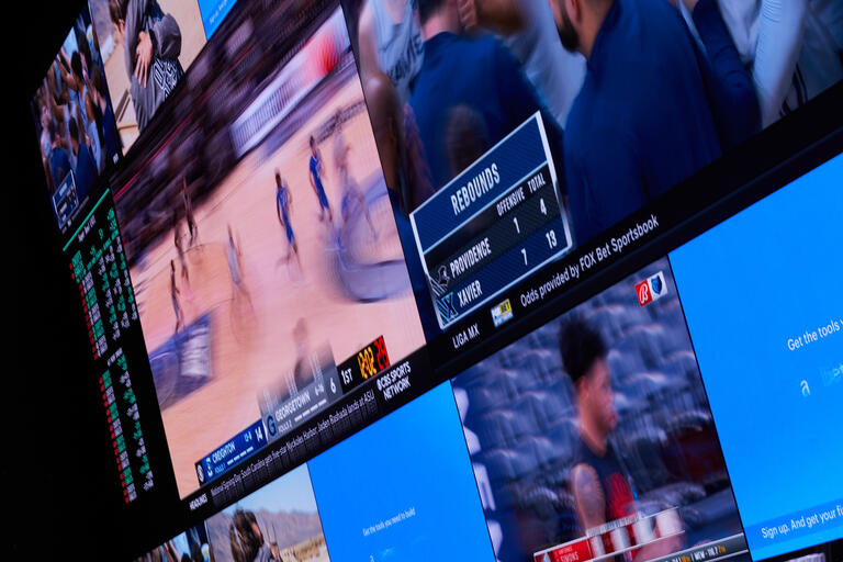 Sportsbook TV screens showing college basketball