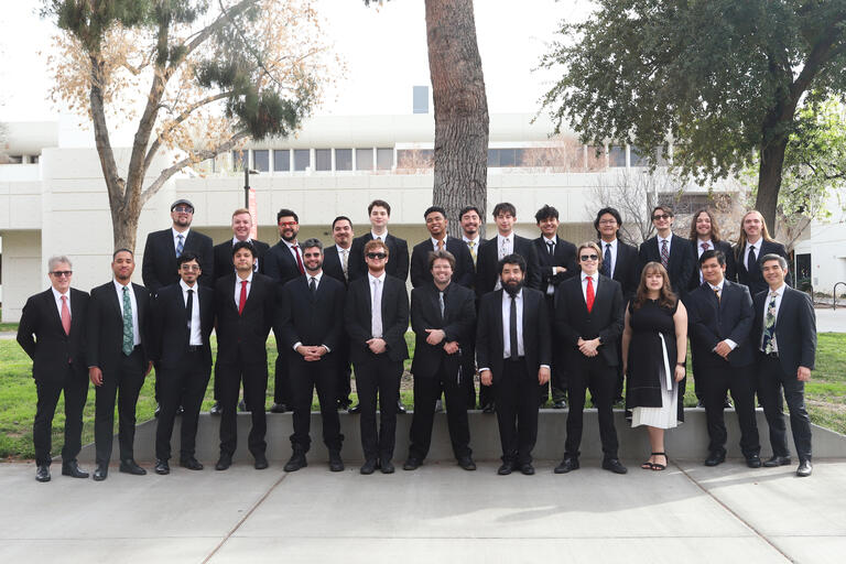 the UNLV jazz ensemble poses as a group outside