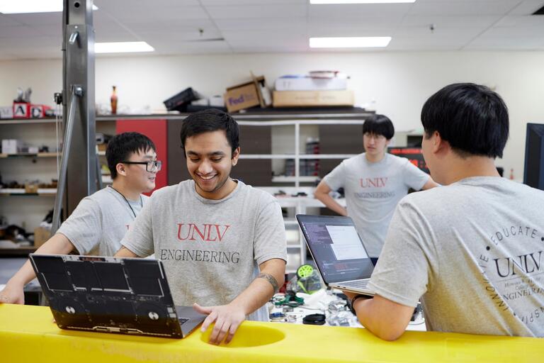 A group of engineering students working on a robotics project.