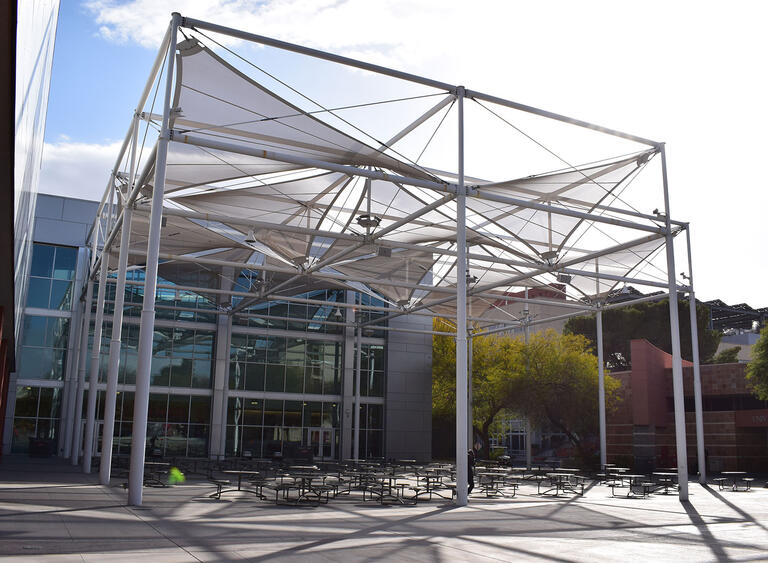 Large concrete patio with a shaded seating area