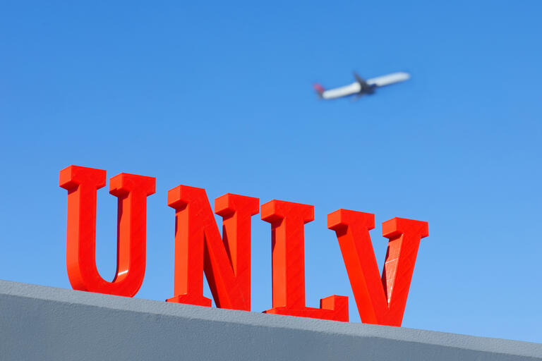 UNLV miniature letters with an airplane in the background