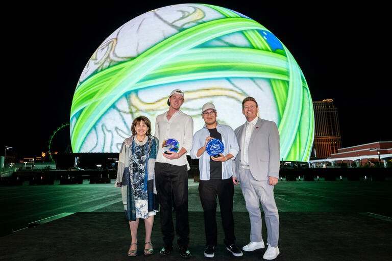 Architecture major Sebastian Rubi and entertainment engineering and design major Gage Glass pose in front of the Exopshere after winning the Sphere XO Student Design Challenge.