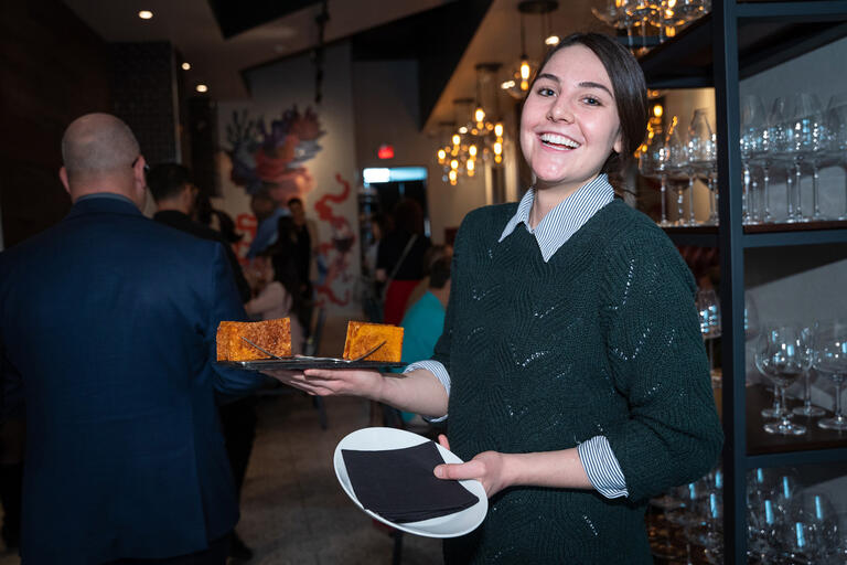 Student holding two plates