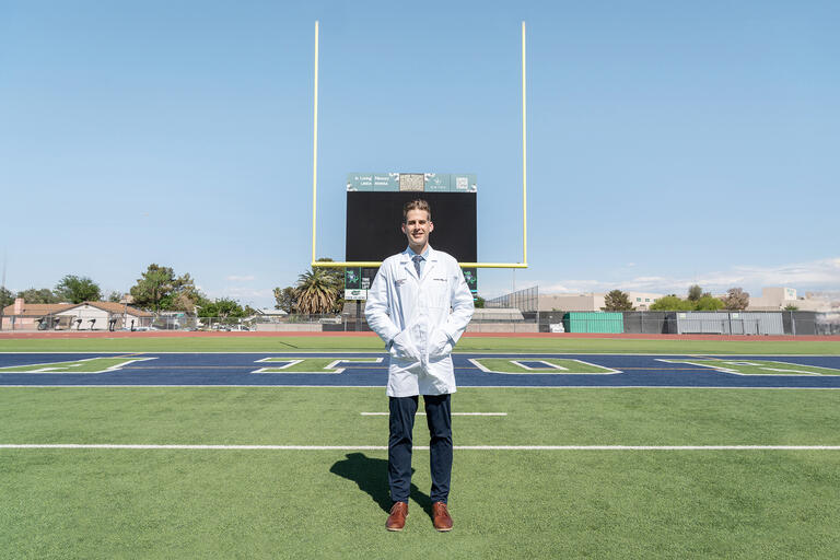 Portrait of Jordan Miller standing in a football field