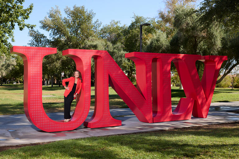 Susan Yunkes inside the &quot;U&quot; of UNLV letters on campus