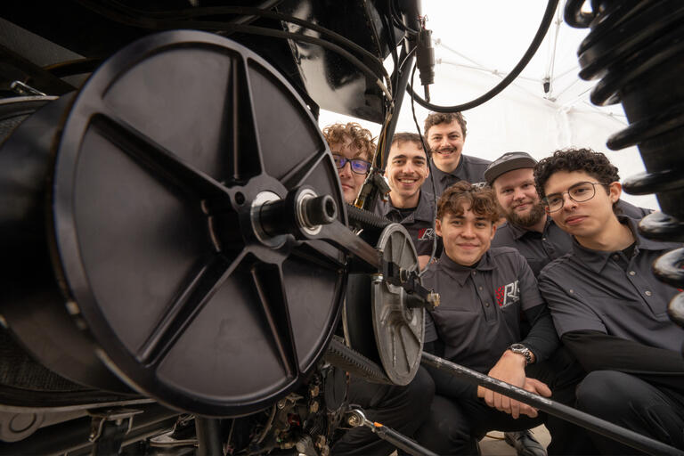 Engineering students look over their Rebel Racing vehicle during the Engineering Senior Design competition.