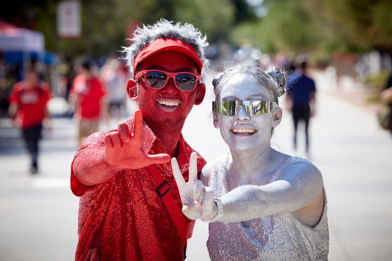 two students in paint celebrating at UNLV
