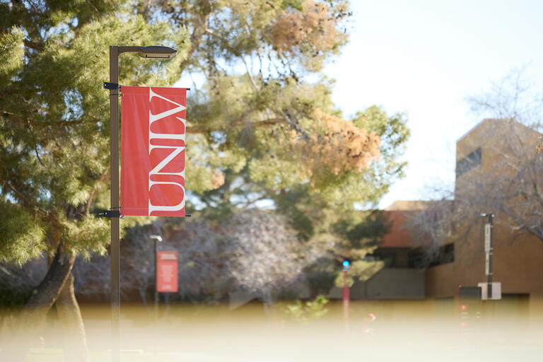 exterior of UNLV campus with red UNLV banner