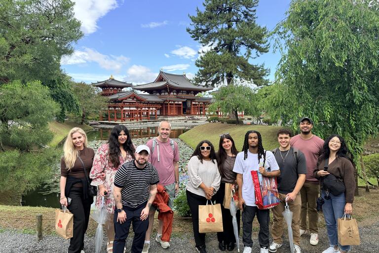 MBA students with a Japanese torii gate behind the group