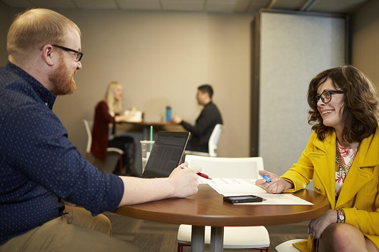 Supervisor meets with employee at an office space
