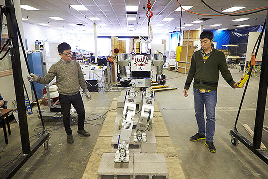 Members of DRC-HUBO at UNLV team working on a robot