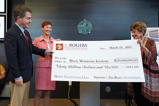 Len Jessup, Beverly Rogers, and President Emerita hold up giant check