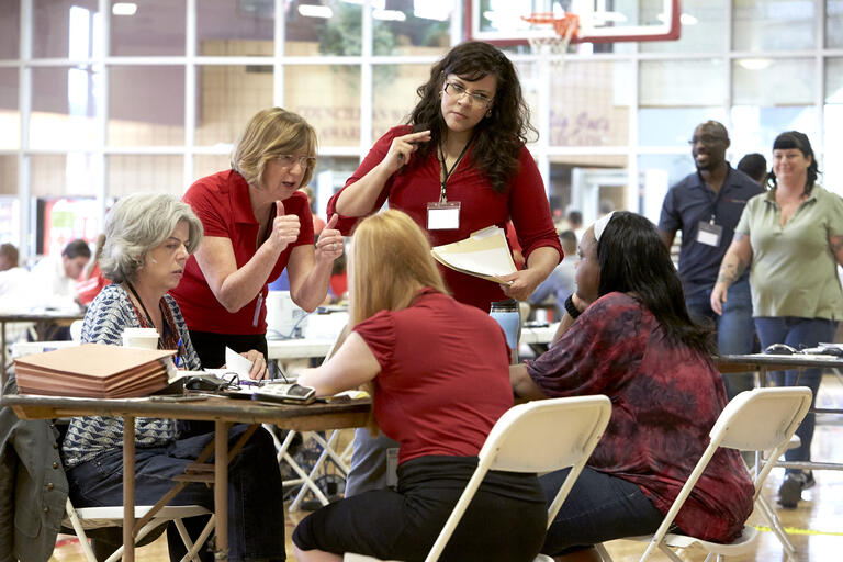 A law professor and legal professionals consult with a client.