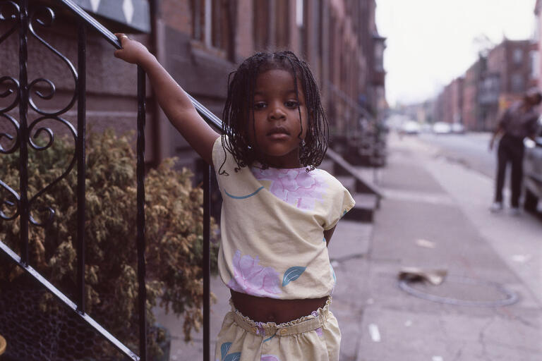 image of young black girl on city street