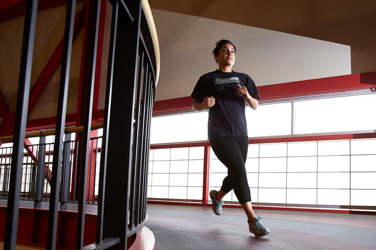 Student jogs in indoor facility