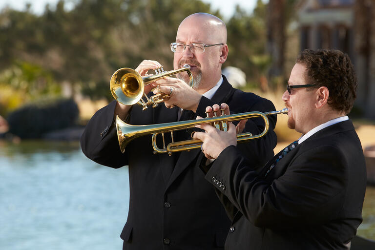 Gary Cordell and Larry Ransom play trumpet at a funeral