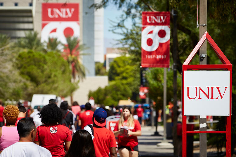Students walk by UNLV signs