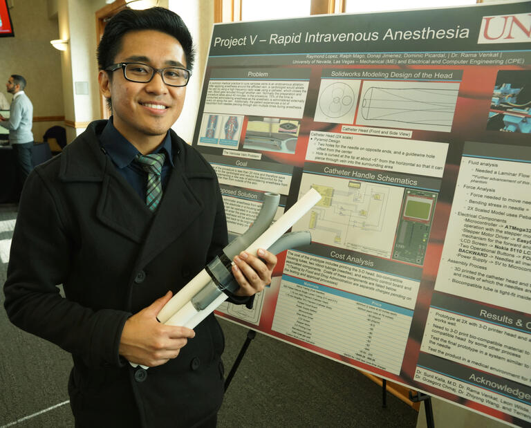 A student holding his project