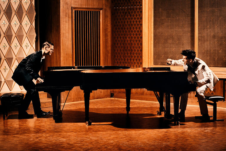 Andreas Kern and Paul Cibis look at each other from across a grand piano