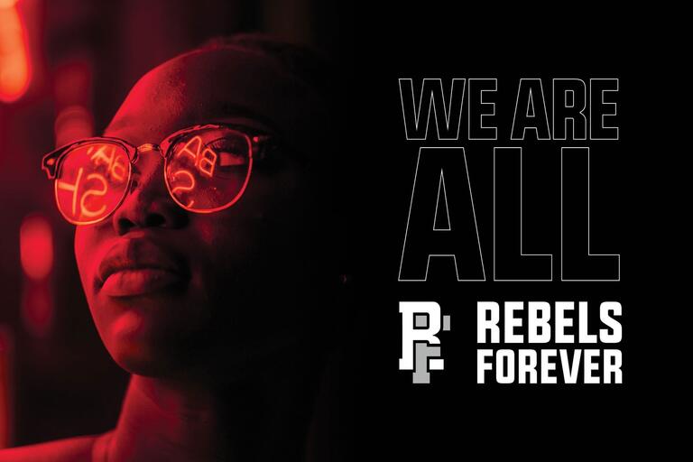 person with glasses looking into distance with Rebels Forever logo