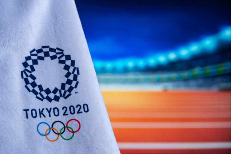 flag emblazoned with Tokyo 2020 and Olympic rings