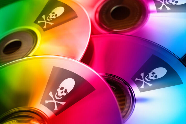 CDs with stickers featuring pirate crossbones symbol