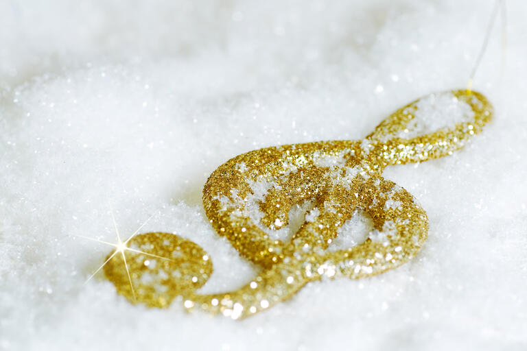 Gold music symbol in snow