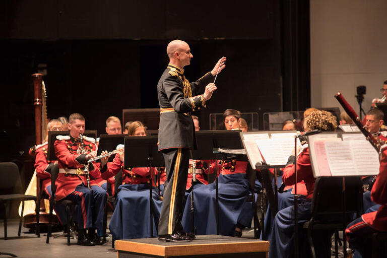 marine band conductor and musicians on stage