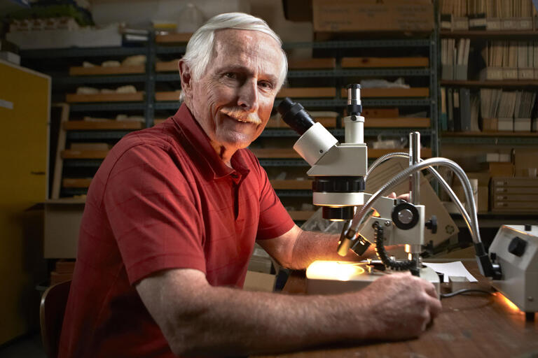 Photo of Steve Rowland with microscope.