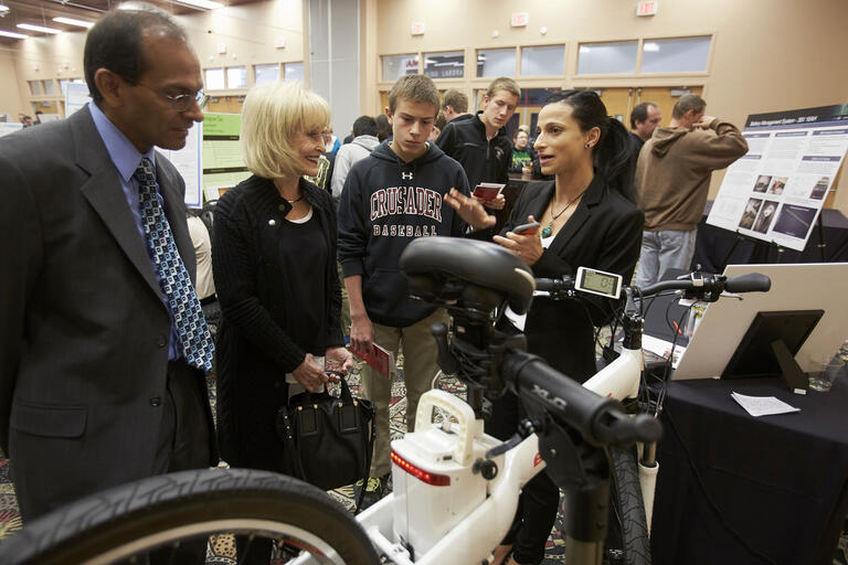 people gathered around a bicycle