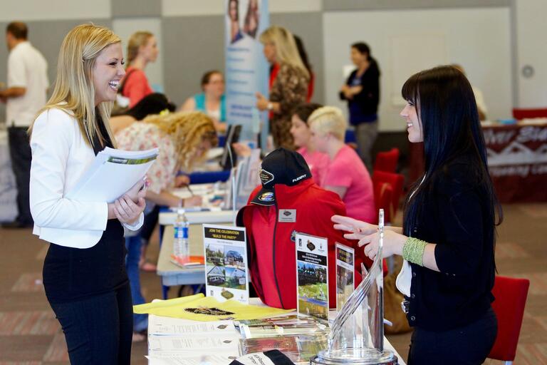 Student visits a table at Career Fair