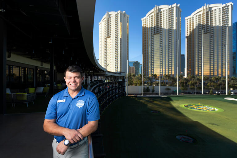 A golfer at a driving range.