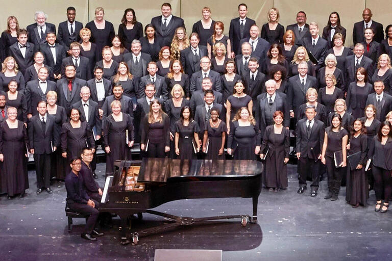 The UNLV Choral Ensembles on the stage of the Artemus W. Ham Concert Hall.