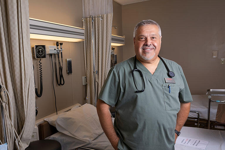 Dr. Salvatore Biazzo standing next to a hospital bed