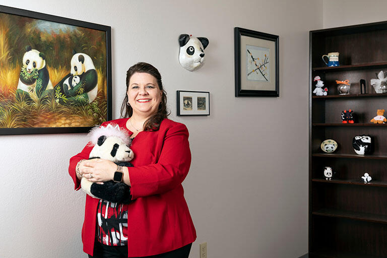 Lori Ciccone standing in her office among her office's decorations