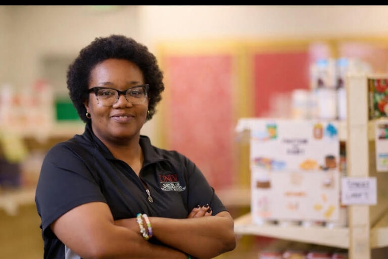woman smiling in UNLV's food pantry