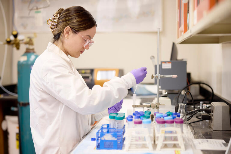 graduate student performing lab work