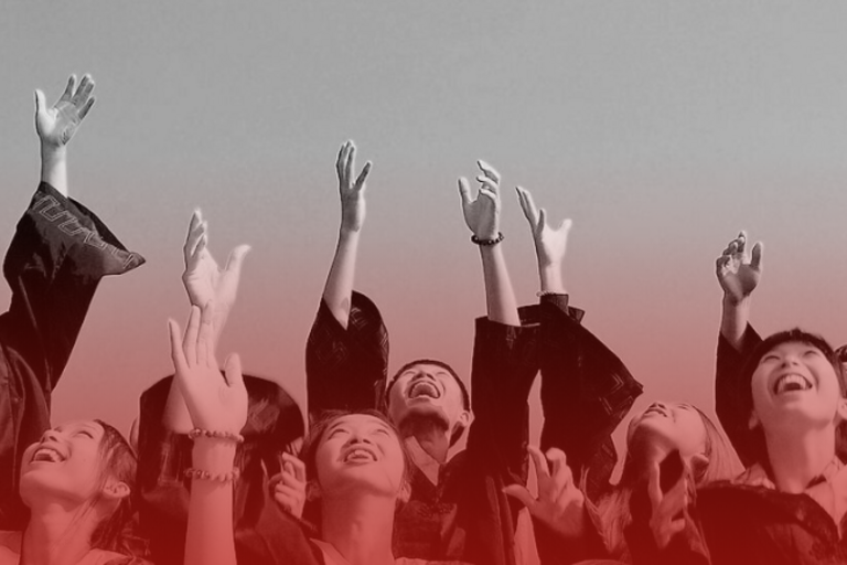 graduates with hands in the air